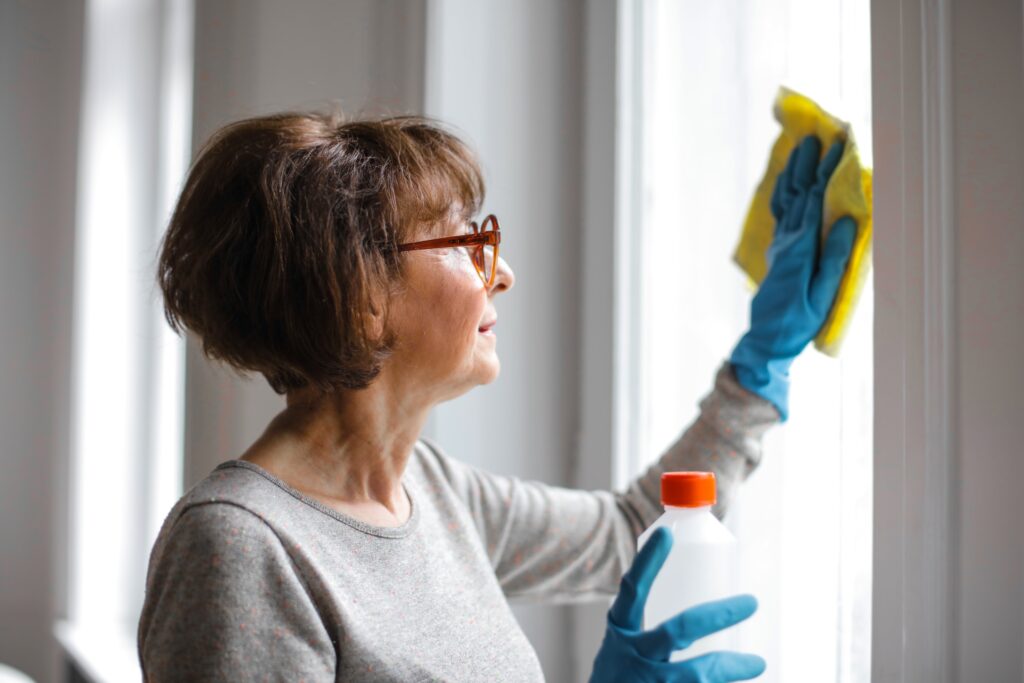 Window cleaning - woman cleaning windows, why we need to clean.